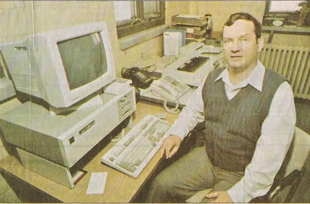 Photograph of Mike Justice at his computer desk in his Wastewater Treatment Plant office